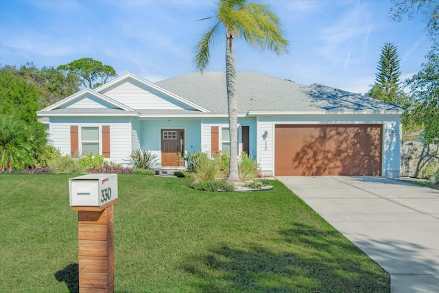 ranch-style home with concrete driveway, a garage, a front yard, and a shingled roof