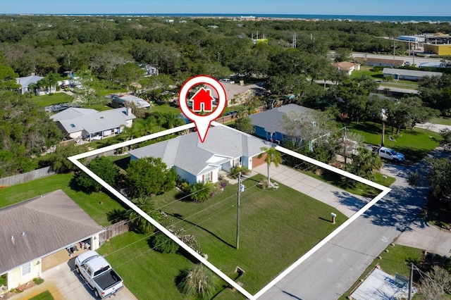 birds eye view of property with a wooded view