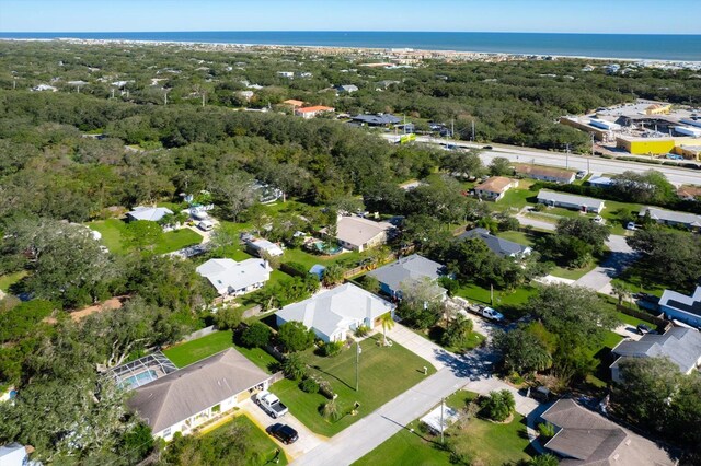 birds eye view of property with a forest view and a water view