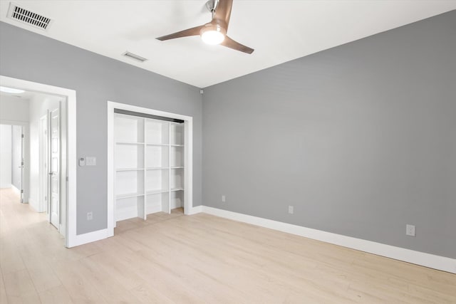 unfurnished bedroom with visible vents, ceiling fan, light wood-type flooring, and baseboards