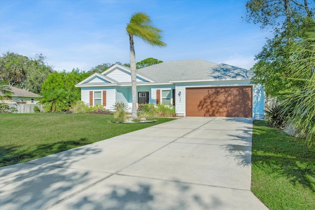 ranch-style house with a garage, concrete driveway, and a front yard