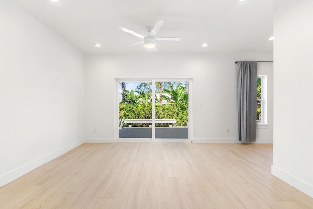 spare room with ceiling fan, a healthy amount of sunlight, and light hardwood / wood-style flooring