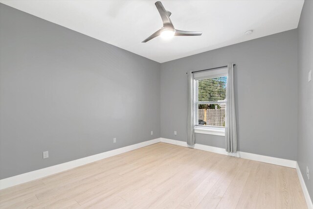 spare room with ceiling fan, baseboards, and wood finished floors