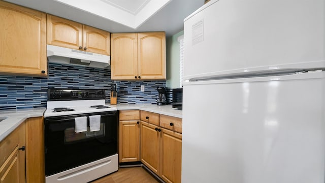 4250 A1A S B16 Unit B16, Saint Augustine, FL 32080 - kitchen featuring freestanding refrigerator, range with electric stovetop, under cabinet range hood, and light countertops