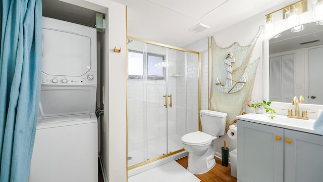 4250 A1A S B16 Unit B16, Saint Augustine, FL 32080 - bathroom featuring stacked washer / dryer, a shower stall, vanity, and wood finished floors