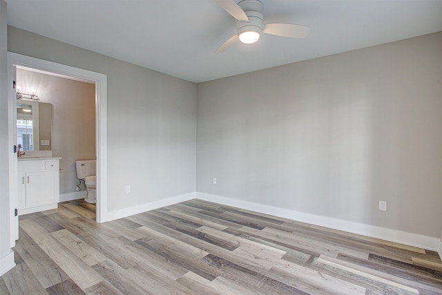 empty room with ceiling fan, sink, and light hardwood / wood-style floors