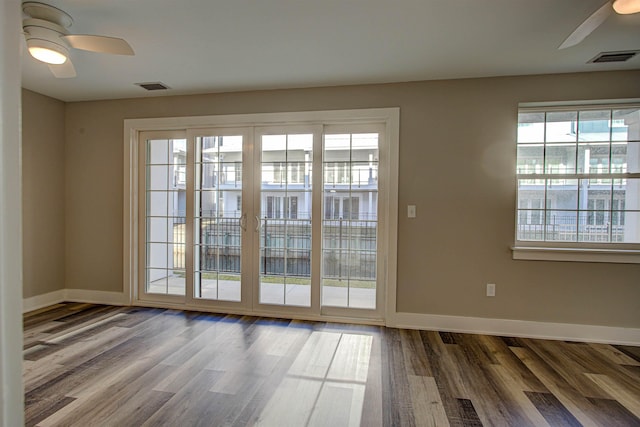 doorway featuring ceiling fan and hardwood / wood-style floors