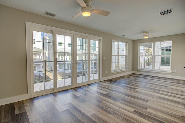 doorway featuring hardwood / wood-style flooring, ceiling fan, and french doors