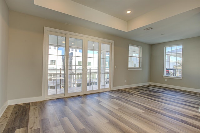 entryway featuring hardwood / wood-style flooring and a raised ceiling