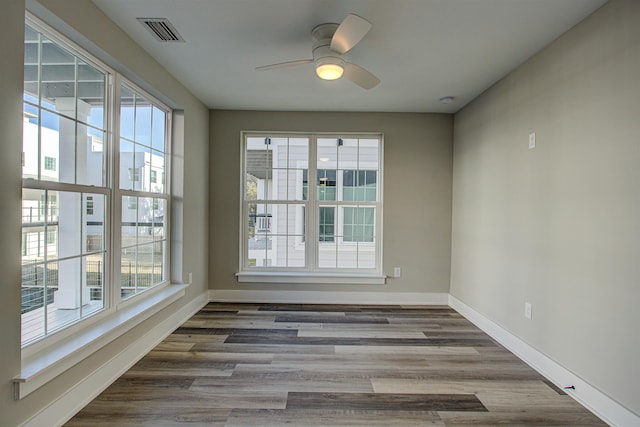 unfurnished room featuring dark hardwood / wood-style flooring and ceiling fan