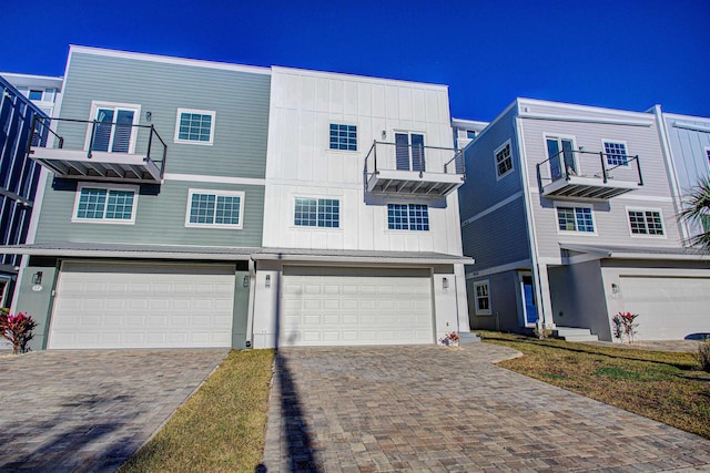 multi unit property with a balcony and a garage