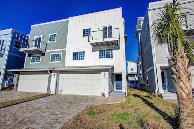 multi unit property featuring a garage and a balcony