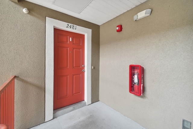 view of exterior entry featuring stucco siding