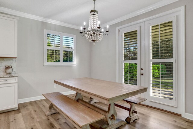 119 Duck Pond Dr, Saint Augustine, FL 32086 - dining space with an inviting chandelier, crown molding, light wood-style floors, and baseboards