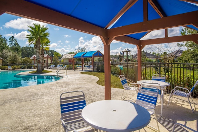 119 Duck Pond Dr, Saint Augustine, FL 32086 - community pool with a patio, outdoor dining area, and fence