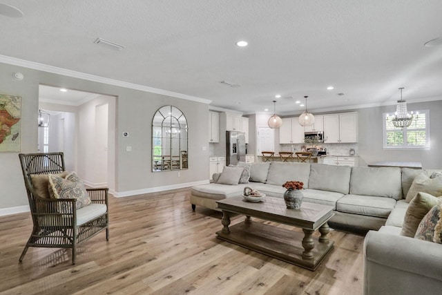119 Duck Pond Dr, Saint Augustine, FL 32086 - living area with baseboards, light wood-style floors, a chandelier, and ornamental molding