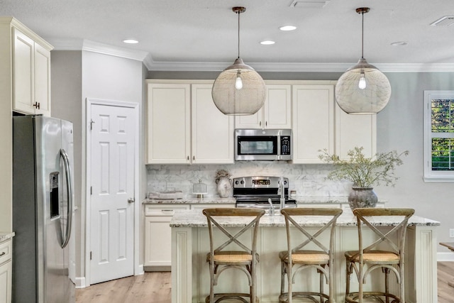 119 Duck Pond Dr, Saint Augustine, FL 32086 - kitchen featuring visible vents, light wood-style flooring, decorative backsplash, appliances with stainless steel finishes, and crown molding