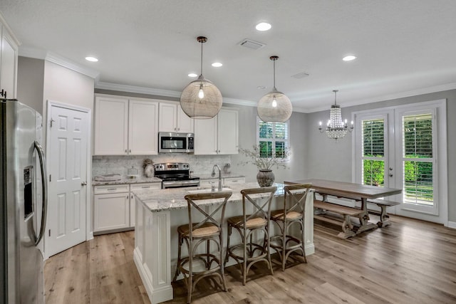 119 Duck Pond Dr, Saint Augustine, FL 32086 - kitchen with tasteful backsplash, light stone counters, appliances with stainless steel finishes, plenty of natural light, and white cabinets