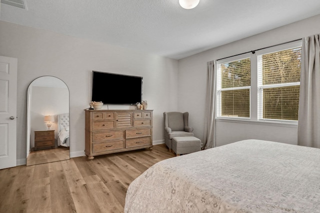 119 Duck Pond Dr, Saint Augustine, FL 32086 - bedroom featuring visible vents, baseboards, a textured ceiling, and light wood finished floors