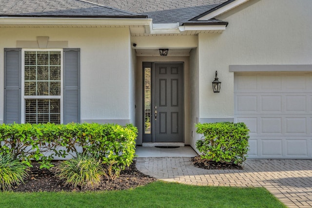 119 Duck Pond Dr, Saint Augustine, FL 32086 - entrance to property featuring stucco siding, an attached garage, and a shingled roof