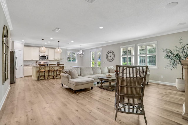 119 Duck Pond Dr, Saint Augustine, FL 32086 - living room with a notable chandelier, light wood-style flooring, baseboards, and ornamental molding