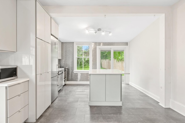 kitchen with white cabinetry and appliances with stainless steel finishes