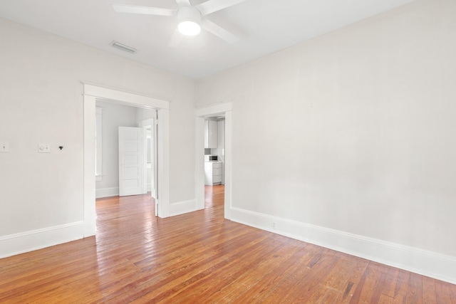 empty room with ceiling fan and light wood-type flooring