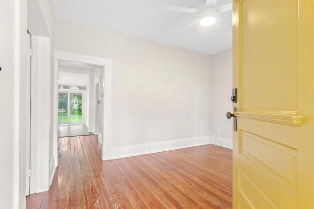 unfurnished room with ceiling fan and wood-type flooring