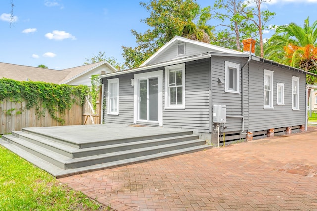 rear view of property with a wooden deck