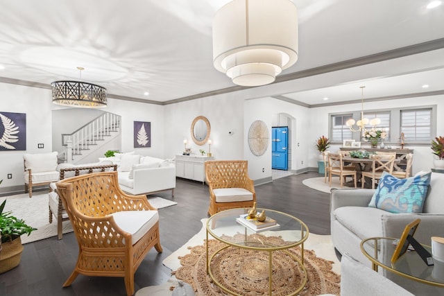 living room with a notable chandelier, crown molding, and dark hardwood / wood-style floors