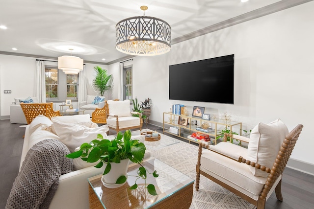 living room featuring ornamental molding, dark hardwood / wood-style floors, and a notable chandelier