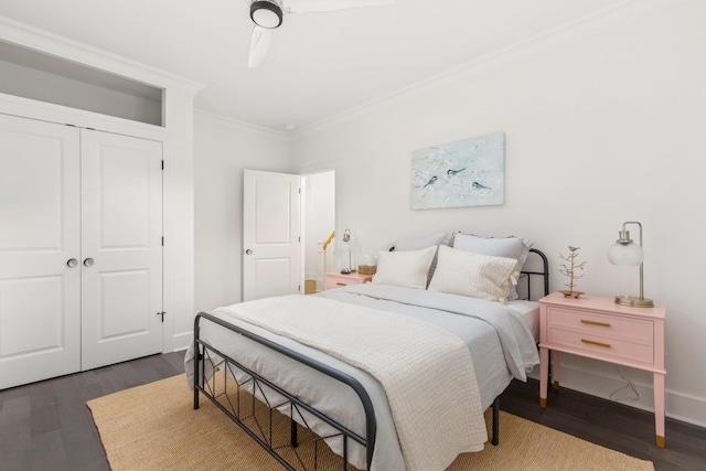 bedroom with dark hardwood / wood-style floors, ornamental molding, and a closet