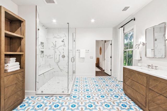 bathroom with vanity and a shower with shower door