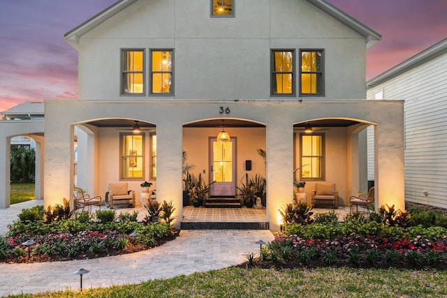 view of front of property featuring an outdoor living space and a patio