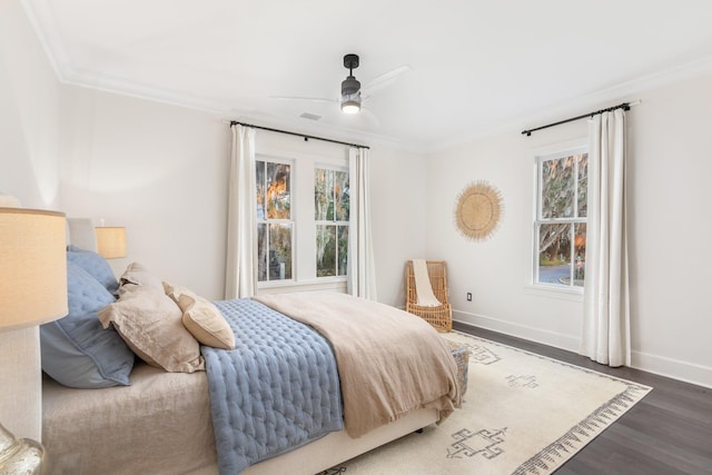 bedroom featuring multiple windows, crown molding, and dark wood-type flooring