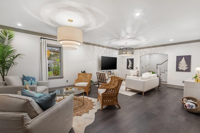 living room featuring dark wood-type flooring and ornamental molding