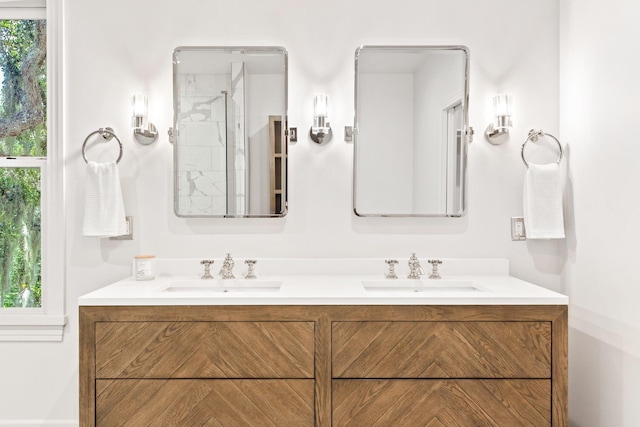 bathroom featuring vanity, plenty of natural light, and walk in shower