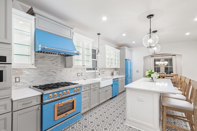 kitchen with sink, range, a center island, dishwasher, and custom range hood