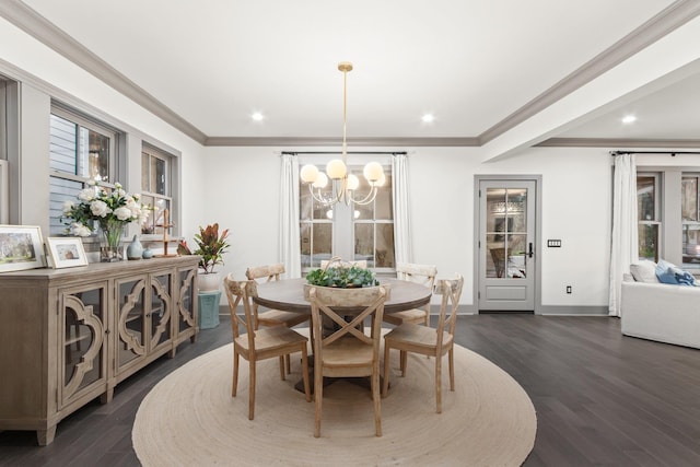 dining space featuring ornamental molding, dark wood-type flooring, and an inviting chandelier