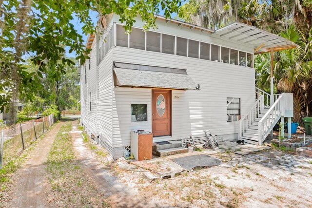 view of front of property featuring a sunroom