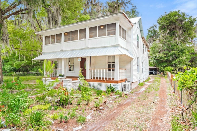 view of front of property featuring ac unit, a porch, and a sunroom