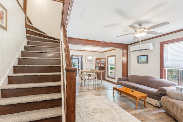 living room featuring light hardwood / wood-style flooring, an AC wall unit, and plenty of natural light