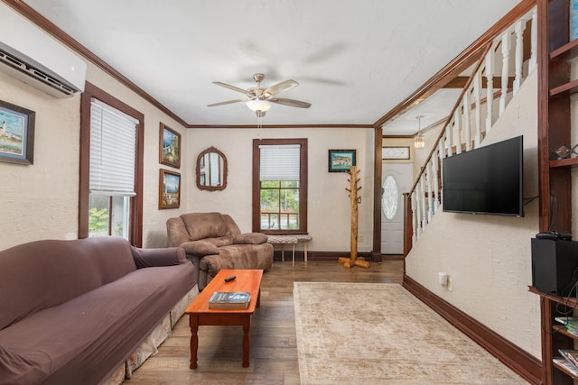 living room featuring a wall unit AC, ceiling fan, dark wood-type flooring, and crown molding