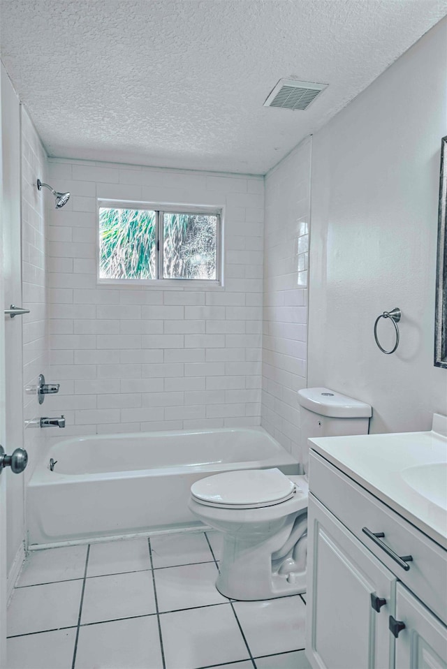 bathroom with vanity, toilet, visible vents, and a textured ceiling