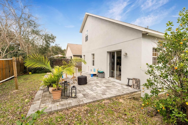 back of property featuring a patio, a fenced backyard, and stucco siding