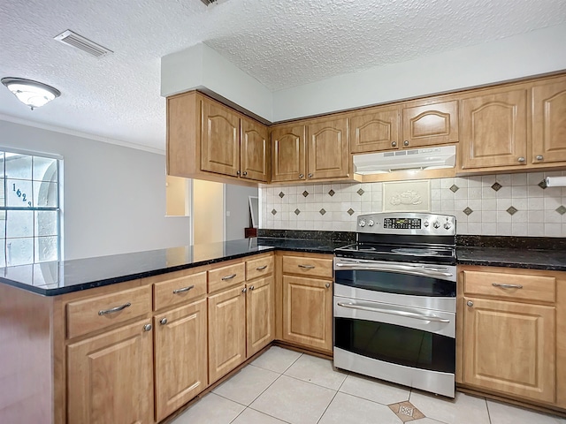 kitchen featuring light tile patterned floors, stainless steel electric stove, dark stone counters, and a textured ceiling