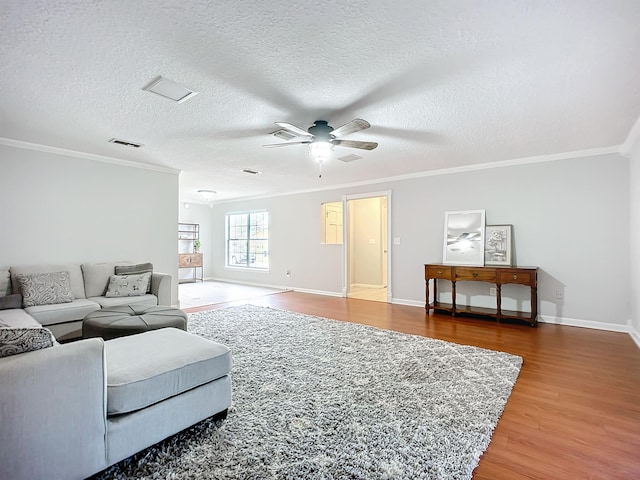 living room with crown molding, hardwood / wood-style floors, a textured ceiling, and ceiling fan