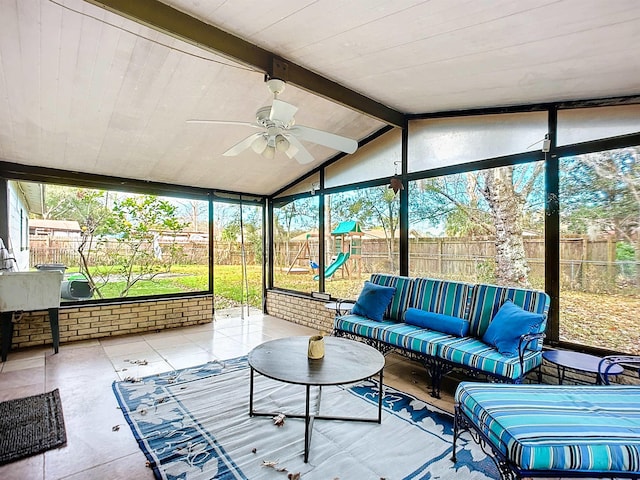 sunroom with lofted ceiling with beams and ceiling fan