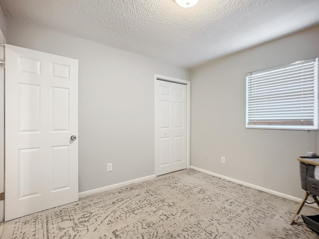 unfurnished bedroom featuring a textured ceiling