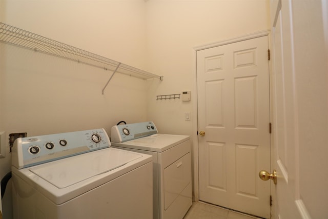 5850 Cypress Estates Dr, Elkton, FL 32033 - washroom with washer and dryer and light tile patterned floors
